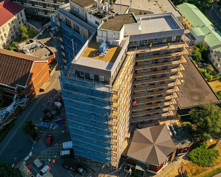 Scaffolding on high rise building, aerial view